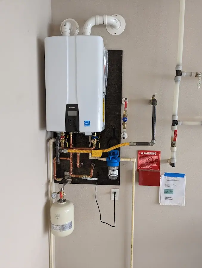 Professional plumber installing copper piping in a Central City home